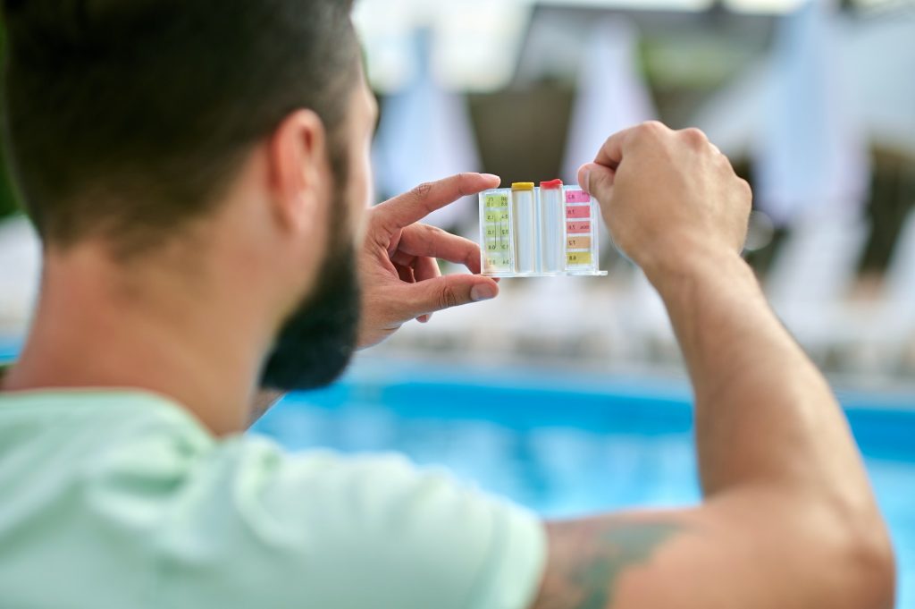 A man holding lacmus paper after water testing